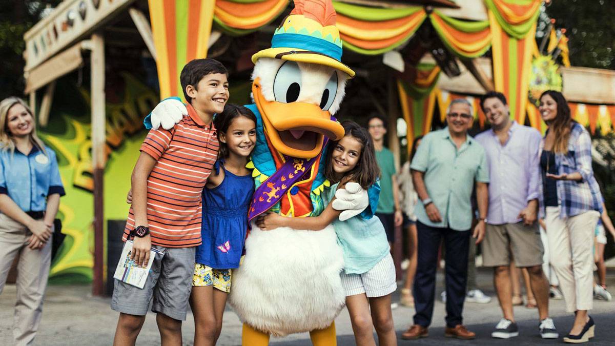 kids hugging donald duck at the disney world welcome center meet and greet with characters