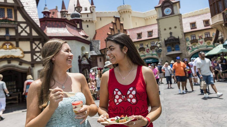 two women eating food at the German Pavilion in Epcot at Disney World Orlando, Florida