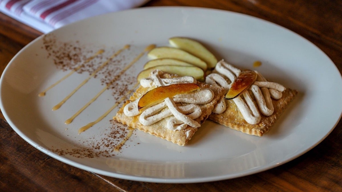 Pastries with apples on a white plate