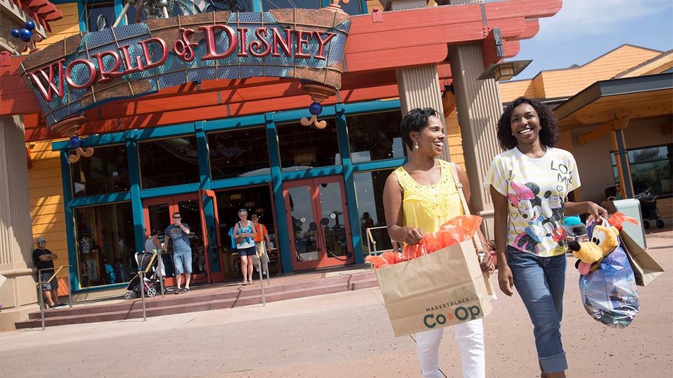 Close up of a mom and her teenage daughter shopping in Disney Springs with World of Disney in Orlando, Florida, USA