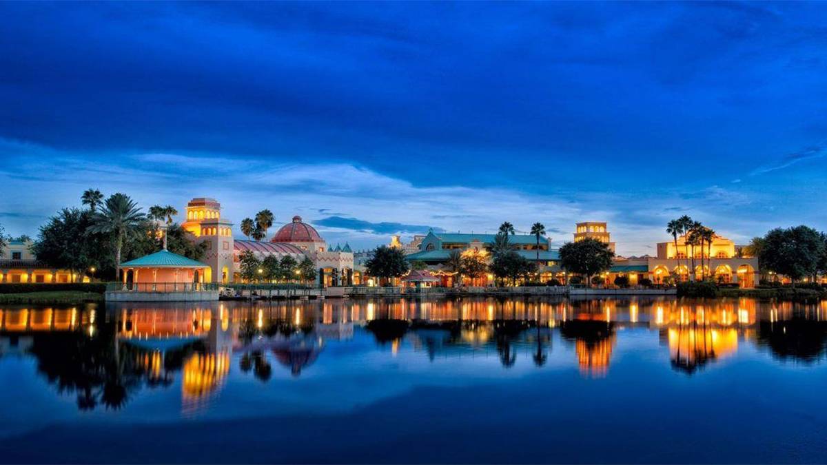 exterior night view of Disney's Coronado Springs Resort with reflection on the water in Orlando, Florida, USA