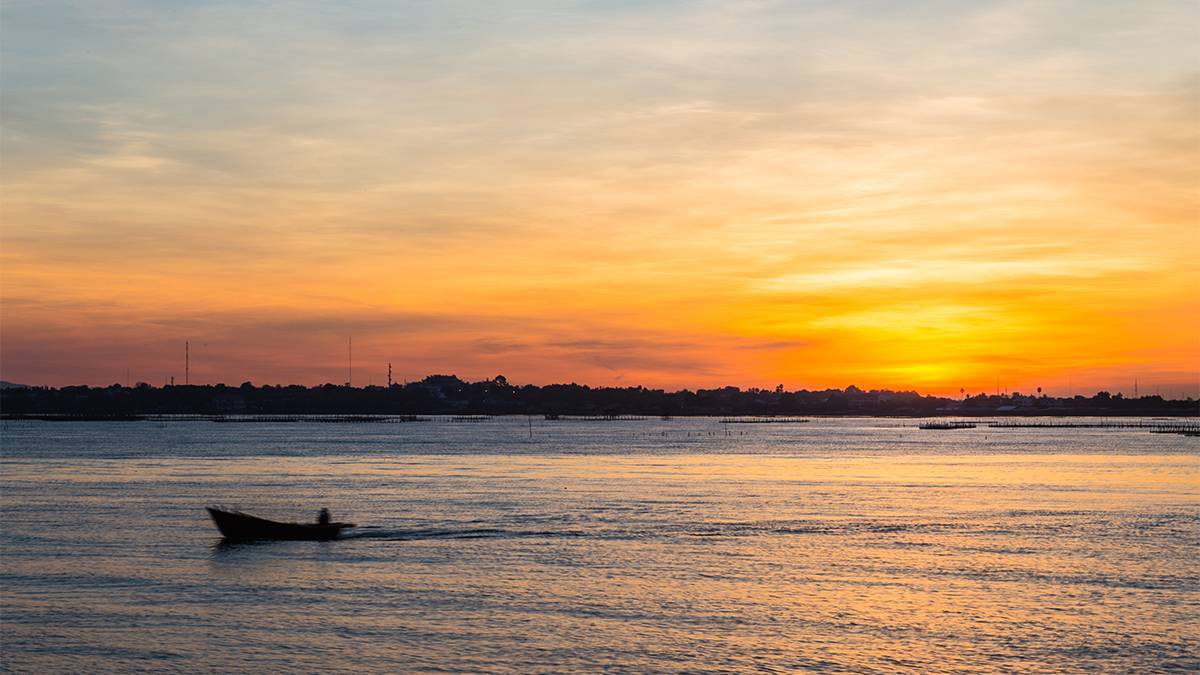 sunset view of fisherman on boat at Lake Tohopekaliga near Orlando, Florida, USA