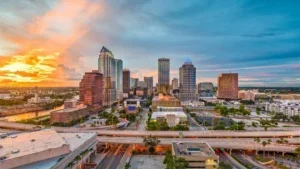 aerial view over downtown with orange sunset in the background over skyline in Tampa, Florida, USA