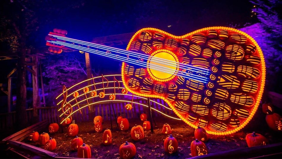 Close up of a glowing pumpkin guitar at the Great Pumpkin LumiNights at Harvest Celebration at Dollywood in Pigeon Forge, Tennessee, USA