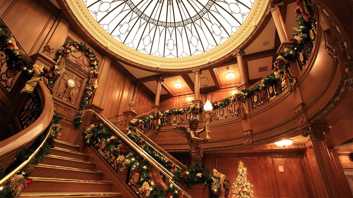 Looking up at the staircase with garland and lights strung all over at the Titanic Museum in Pigeon Forge, Tennessee, USA