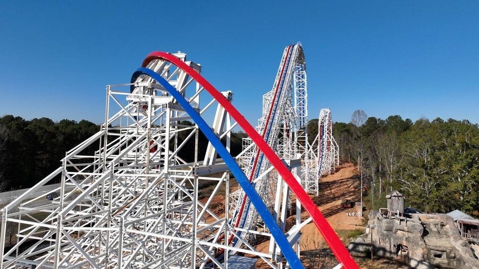 Wide shot of a white roller coaster with red and blue tracks at Fun Spot America Atlanta