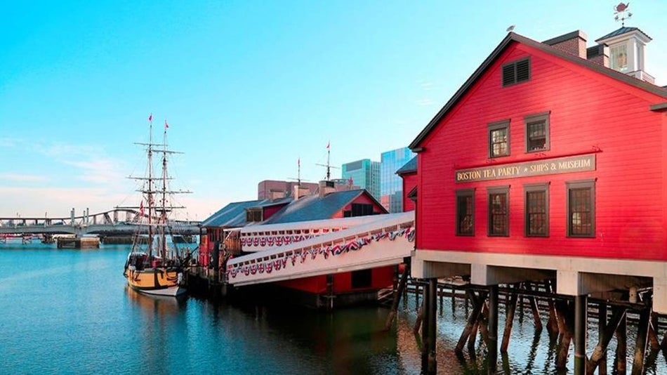 Exterior of red building and old ship at the Boston Tea Party Ships & Museum
