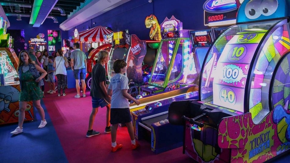 Indoor arcade area full of children playing games at FunDimension in Miami