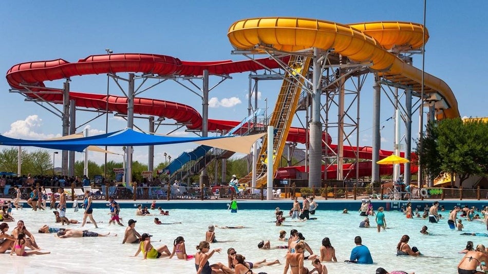yellow and red slides over a pool at hurricane harbor in phoenix