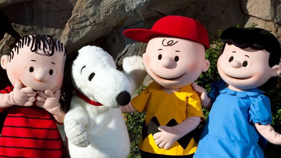 Four peanuts characters standing in a line
