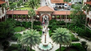 Aerial view of gardens and palm trees along with Spanish style buildings at Flagler college
