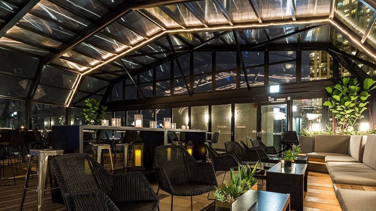 Moody bar on a rooftop with a glass ceiling in Chicago