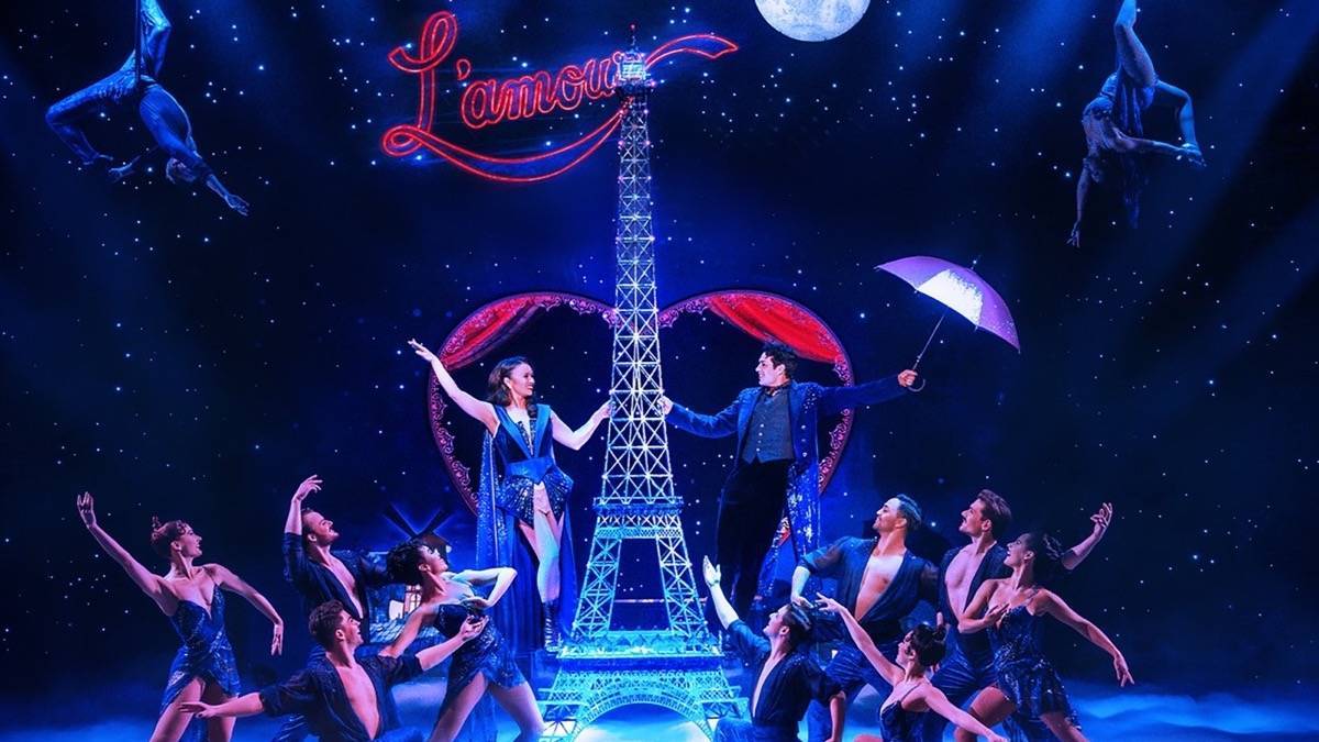 Eiffel tower with cast of Moulin Rouge Musical on stage