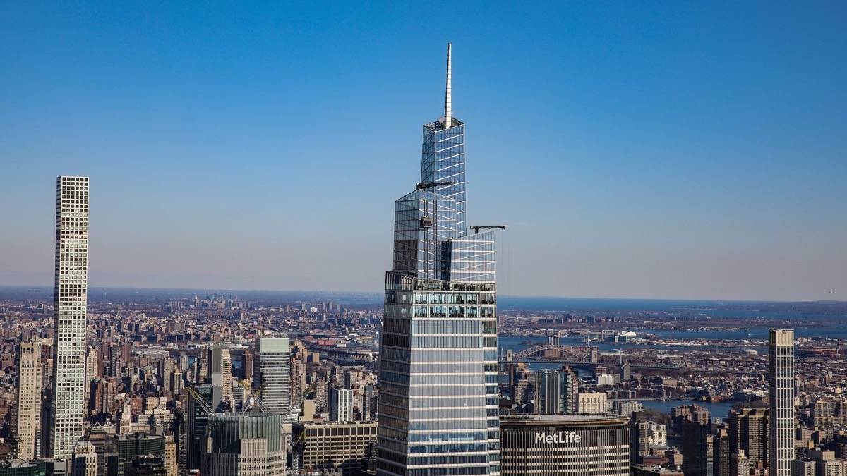 View of Summit one Vanderbilt skyscraper with NYC in the background under a blue sky
