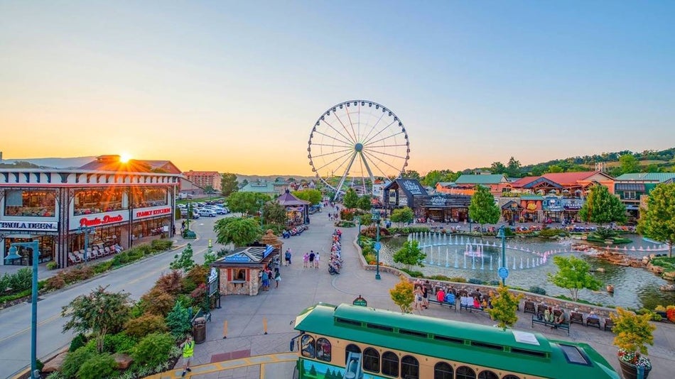 The island in Pigeon forge, restaurants and a shopping area with a ferris wheel at sunrise.