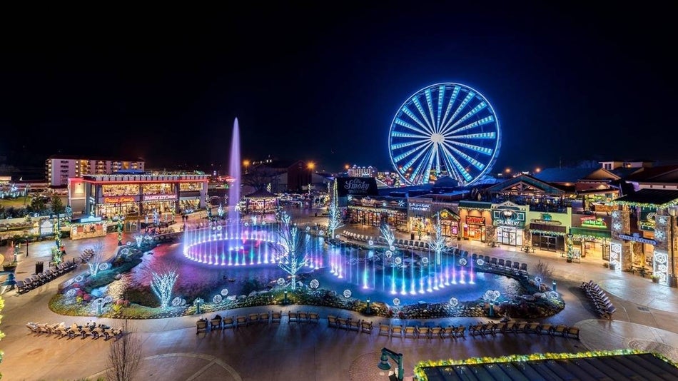 The island shopping area at night lit up from ferris wheel and fountain show