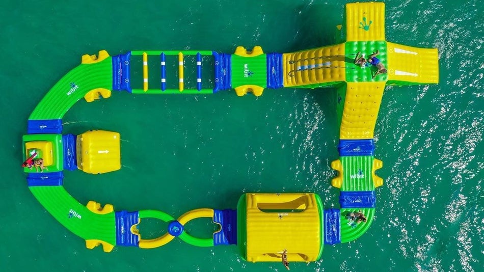 Aerial view of a blowup area with slides, tubes, and rolling logs.