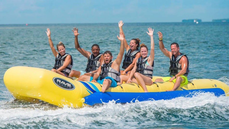 Several people on a banana boat tube