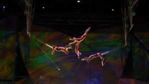 Several acrobats doing tricks through the air
