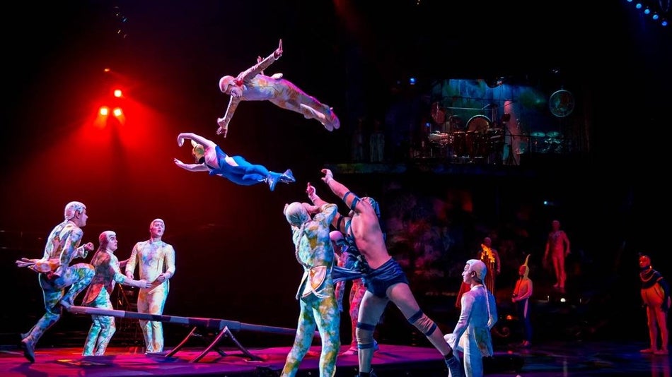 acrobats on stage for Mystère by Cirque du Soleil performing stunts
