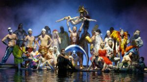 Cast of O by Cirque du Soleil standing on stage