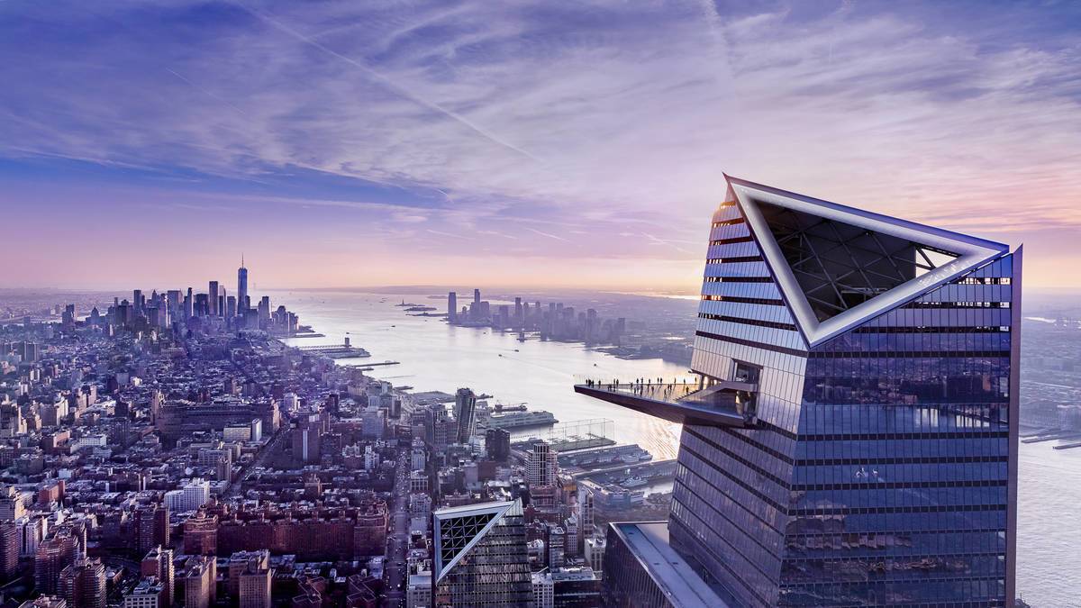 Wide shot of the Edge observation desk with lower manhattan in the background at sunset