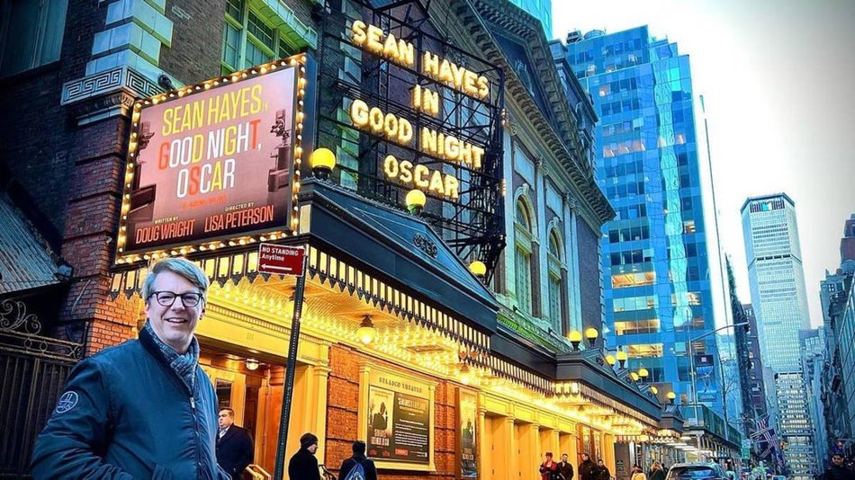 Sean Hayes standing under the marquee of Good Night Oscar in NYC