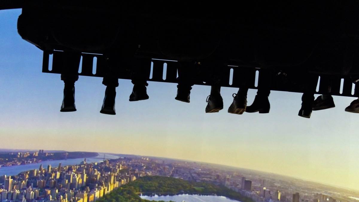Scene from experience of RiseNy, seats over a big screen giving the appearance of soaring over nyc
