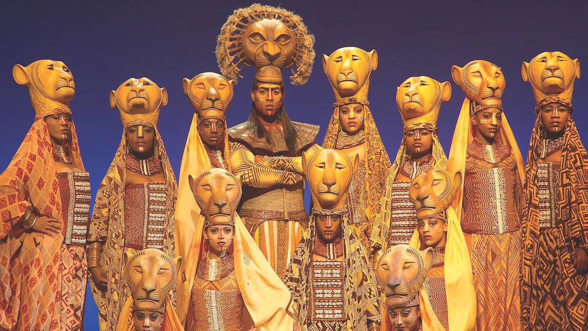 Cast members dressed as lions in the lion king