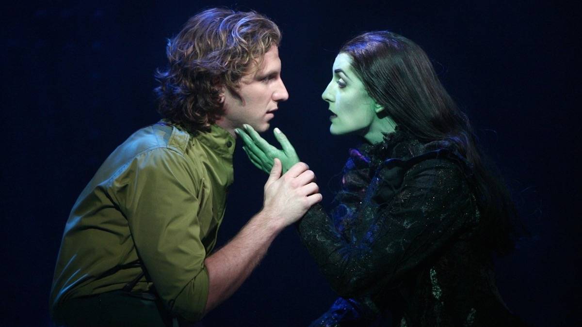 Witch and man lovingly looking at each other while holding each others faces