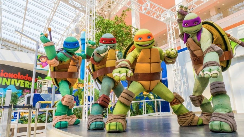 Four ninja turtles posing on a stage