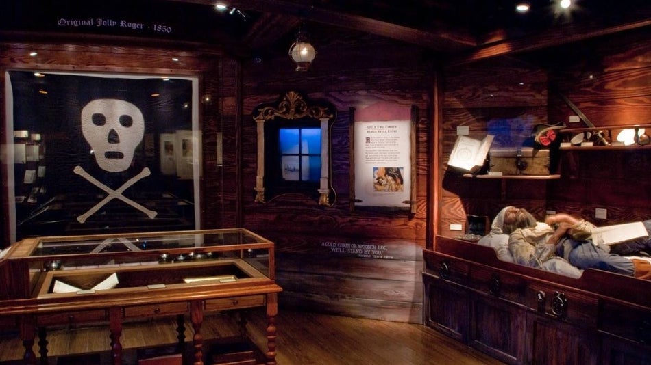 Interior of the pirate museum showing a jolly roger and pirate bunks