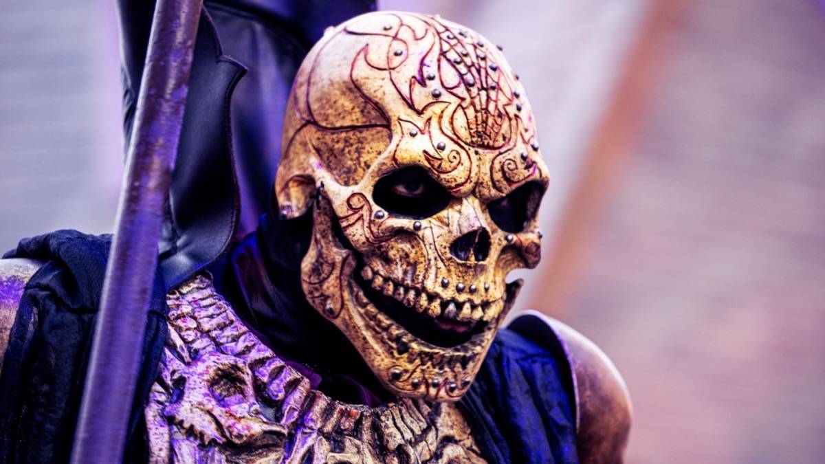 Scare actor in a skull costume