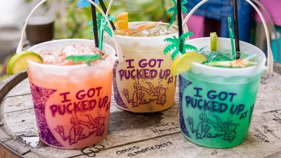 Three different colored buckets of alcoholic drinks