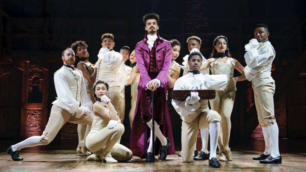 Several cast members in victorian dress on stage at Hamilton