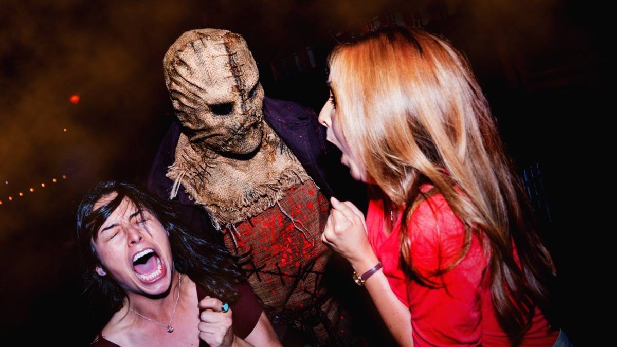 Terrifying scarecrow scaring two women