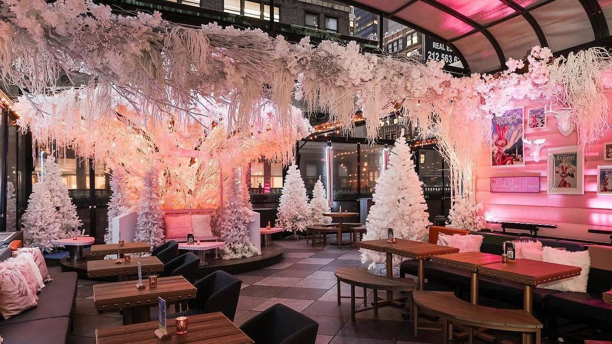 Pink and white wintery decor inside a bar in NYC