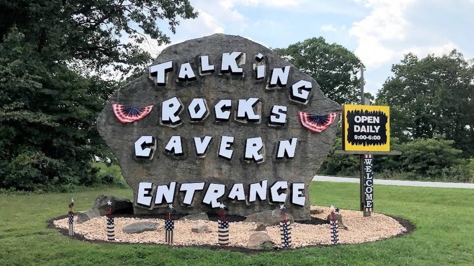 Entrance sign on a large rock to Talking Rocks Cavern in Branson