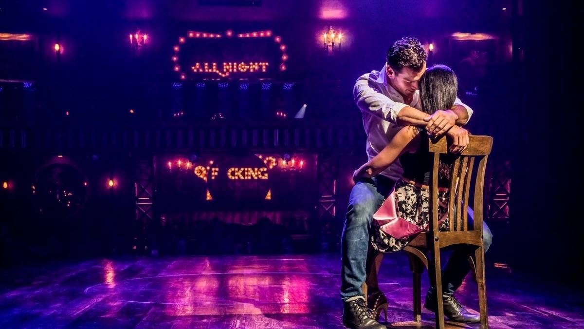 Woman sitting in a chair with a handsome man straddling her on stage at Magic Mike Live in Las Vegas