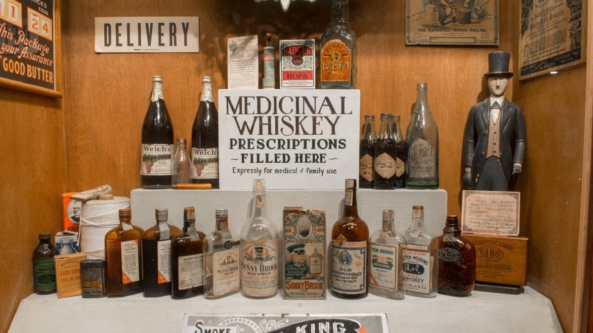 Shelf full of old bottles of medicinal whiskey at the American prohibition Museum
