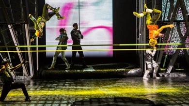 Several performers doing flips on a stage