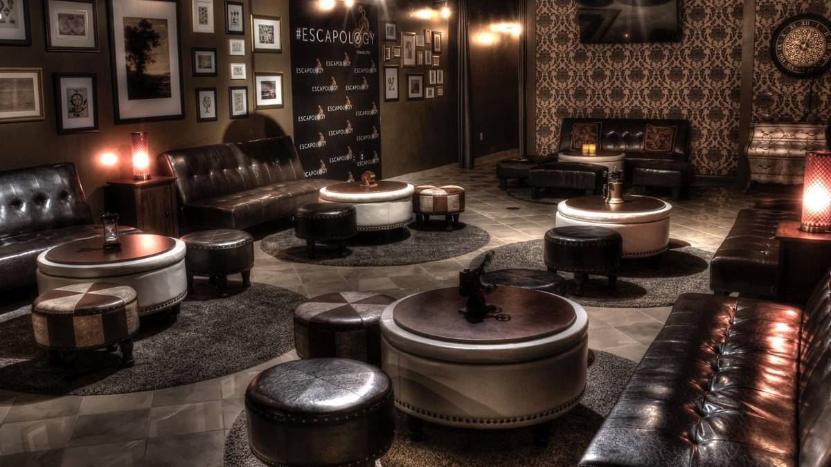 Dimly lit room with leather chairs and coffee tables