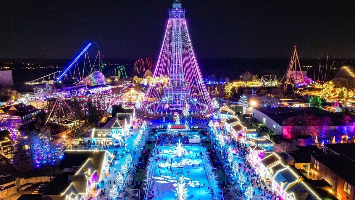 Aerial shot of a theme park done up with Christmas lights