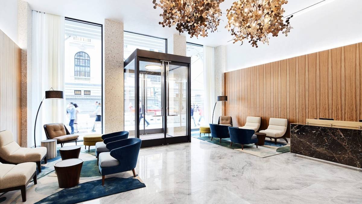 Sleek lobby with marble floors and a white ceiling with modern furniture in NYC