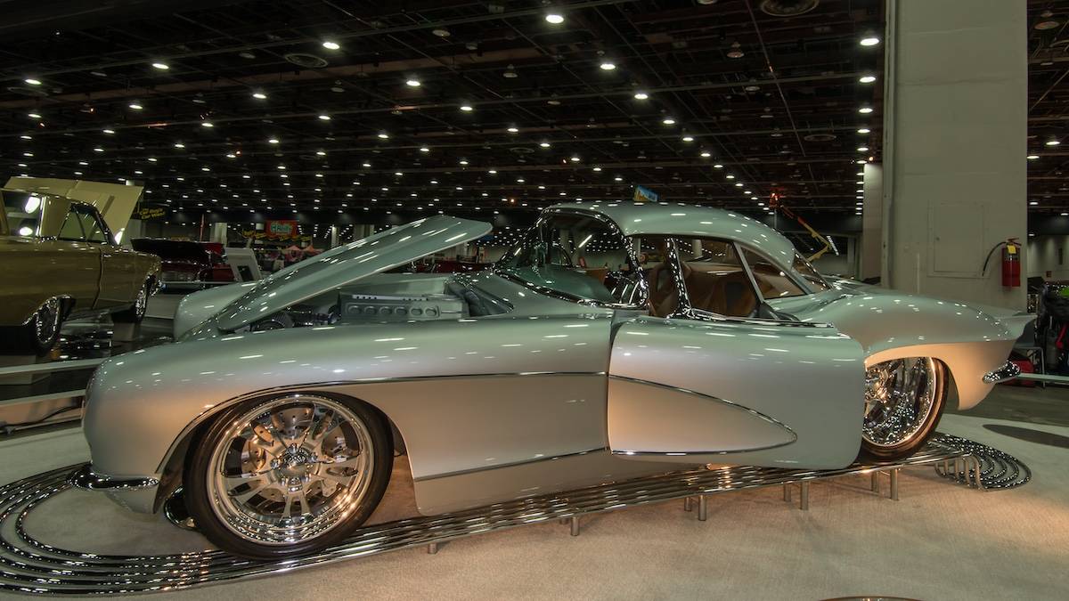 Silver older vehicle at an indoor car show