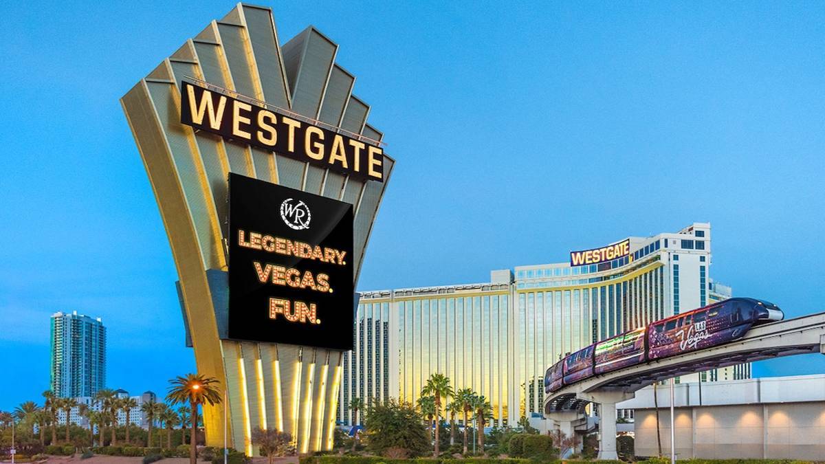 Exterior shot of the Westgate in Las Vegas with a big gold sign that says westgate and a Las vegas monorail running on a track as well