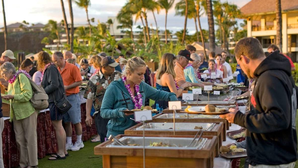Guests at a luau at a large buffet