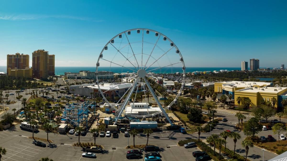 Aerial shot of a ferris wheel at a beach side town