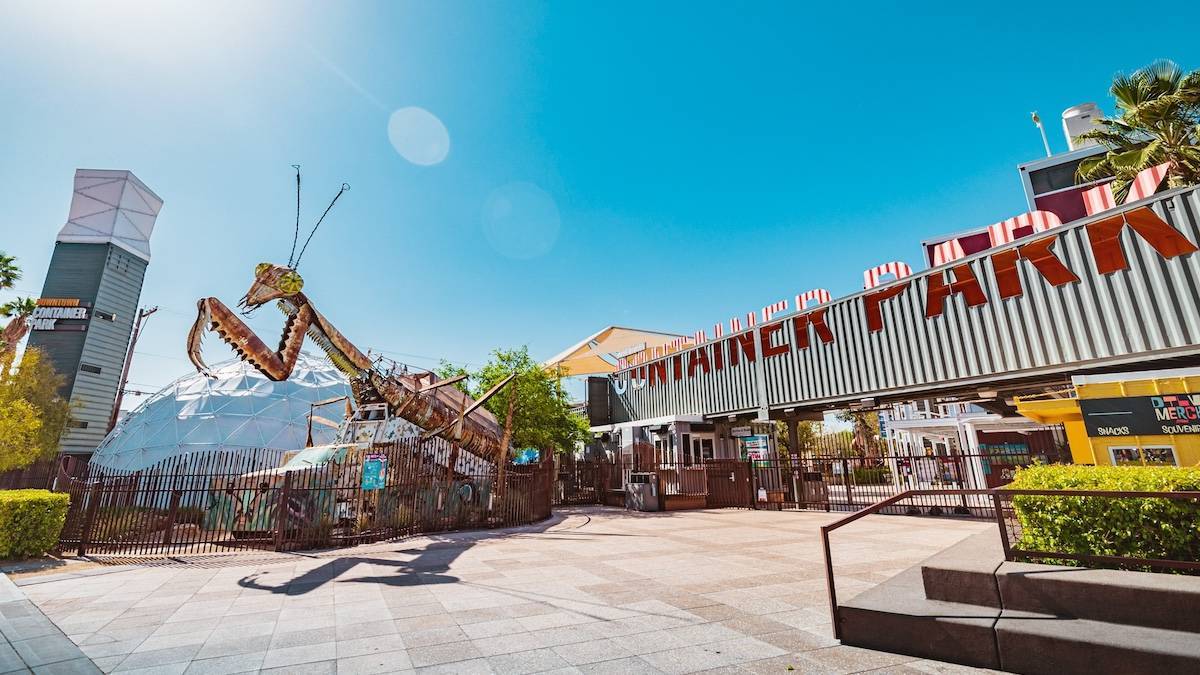 Wide shot of a large metal praying mantis next to the entrance to the Container park in Las vegas
