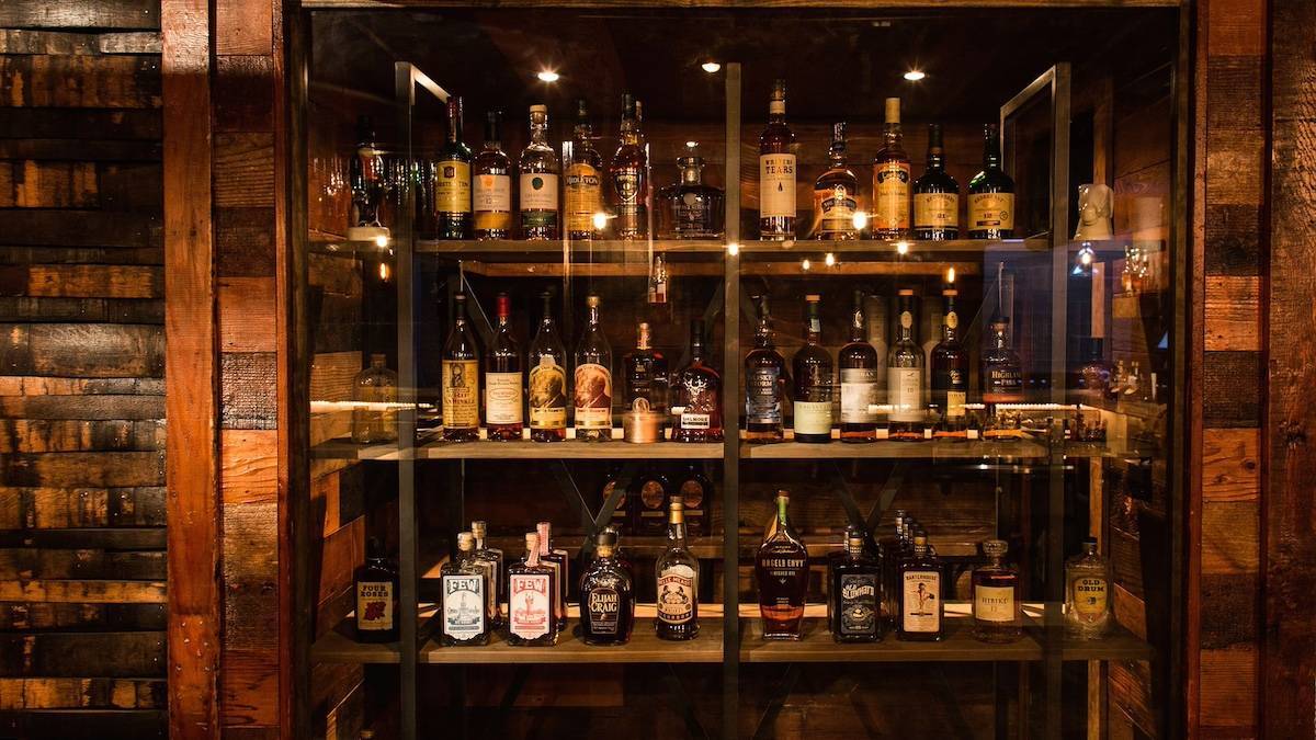 Bar shelves full of bottles of bourbon
